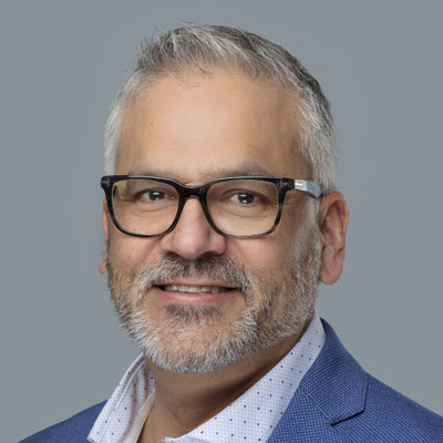 Lyle Bouvier headshot. He is wearing glasses and smiling. He has short greying hair and a goatie.